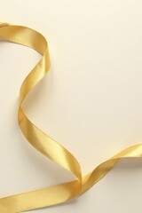 Elegant Golden Ribbon Swirling on a Light Background, Perfect for Festive Designs and Elegant Presentations