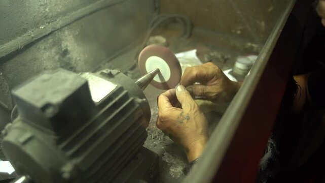 Master silversmith meticulously crafting intricate jewelry using traditional tools and techniques in authentic Balinese workshop