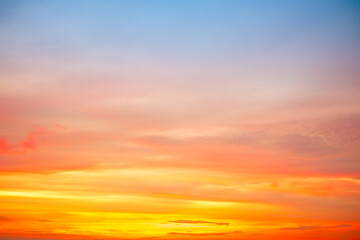 Obraz premium Beautiful , luxury soft gradient orange gold clouds and sunlight on the blue sky perfect for the background, take in evening,Twilight, Large size, high definition landscape photo