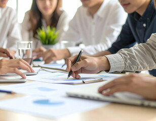 Collaborative Team Analyzing Marketing Data and Charts in Bright Open Workspace in Casual Attire under Bright Lighting