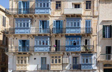 Old houses in Valletta city, island of Malta, with traditional bay windows and colourful shutters and doors.