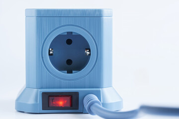 Blue cubic power strip featuring four euro sockets and an illuminated red switch, ideal for organizing and powering multiple home or office electronics without clutter. Photo
