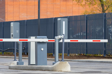 Electronic parking barrier gate with control terminals at the entry point of an industrial or...