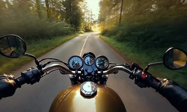 Motorcycle on road amidst trees, sunlight filtering through. POV shot of gauges
