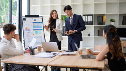 Professional team discussing project performance during a group presentation.