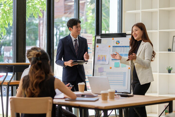Business professionals enjoying a collaborative team presentation in a modern office setting.