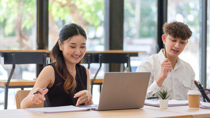 Young professionals working together on a business project in a bright modern office.