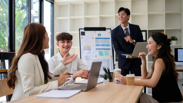 Smiling professionals presenting business analytics during a collaborative team session.