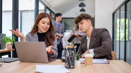 Professional team in active discussion, sharing ideas and business insights in a bright workspace.