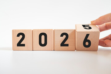Hand-turned wooden cube from 2025 to 2026. New business goal strategy concept. 2026 goal planning business concept