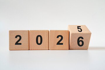 Hand-turned wooden cube from 2025 to 2026. New business goal strategy concept. 2026 goal planning business concept