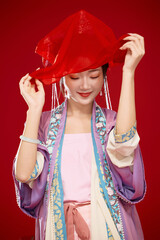 Beautiful woman wearing Chinese Ming Dynasty Hanfu with hairpin and flower ornaments on red...