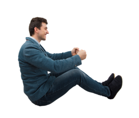 Side view full length portrait of a young smiling businessman driving an imaginary car isolated on transparent background