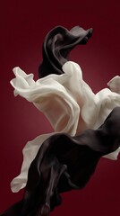 Obraz premium Abstract flowing fabric in black and white against a rich, solid red background. Elegant and dynamic.