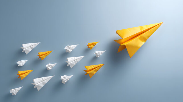 A vibrant yellow paper airplane leads a formation of white crumpled paper airplanes, symbolizing creativity and innovation.