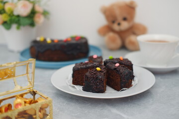 Delicious Chocolate Cake Slices with Sprinkles and a Teddy Bear