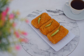Three Delicious Risoles on a White Plate