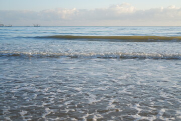 Ocean waves crashing on the shore at sunrise