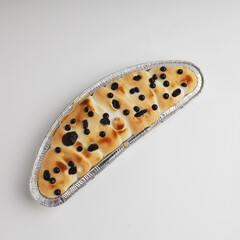 Klapertaart or custard coconut pudding in aluminum foil, traditional dessert from Manado, Indonesia