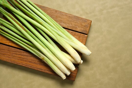 Fresh lemongrass, cymbopogon, serai or sereh on brown background. Herbal and spices plant