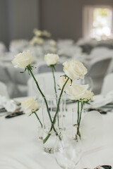 White roses in clear vases wedding table centerpieces