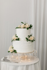 beautiful 2 tier white wedding cake with roses 