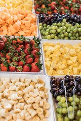 Beautiful Colorful Fruit Serving Platter with Strawberries, pineapples, green and red grapes, cantaloupe and sliced bananas 
