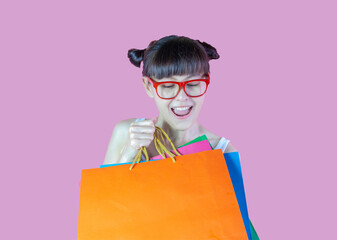 Young woman cheerful wearing eyeglasses  enjoying while holding colorful shopping bags. Lovely lady...