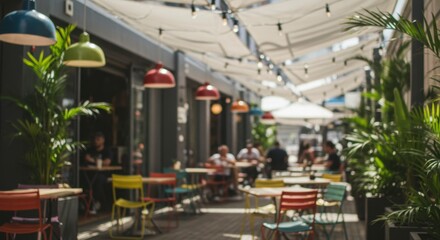 Outdoor cafe terrace with colorful tables, chairs, plants, and lamps under awnings