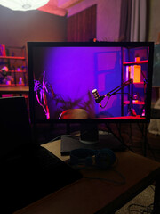 Podcast recording setup with colorful lighting and modern equipment in a creative workspace