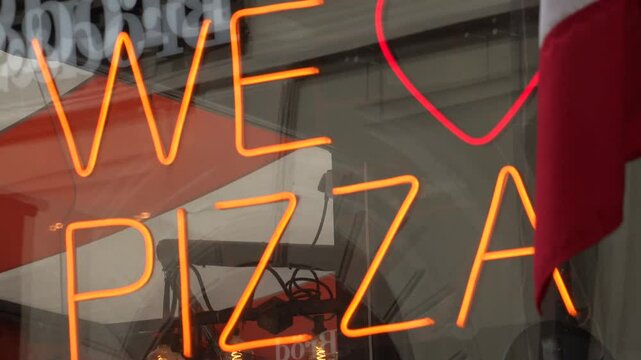 Stockholm, Sweden A We Love Pizza sign in a pizzeria window