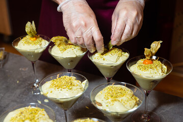 Pistachio dessert preparation in martini glasses.
