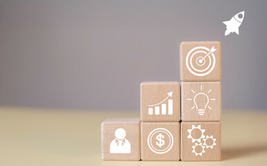 Rocket launch as a symbol of startup success in wood cube. Creativity, innovation, and strategic planning to reach business goals, project targets, and market trends.