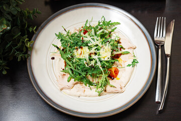 Italian veal with tuna sauce and arugula.