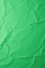 High-resolution image of crumpled green paper texture, perfect for backgrounds, design projects, and artistic endeavors showcasing a vibrant, textured surface.