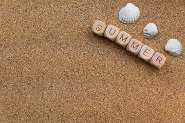 Cork board with Wooden blocks spelling summer and seashells for beach vibes