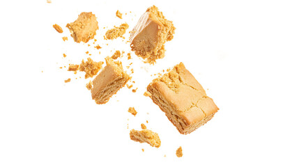 Delicious pieces of crumbly shortbread cookies breaking apart in mid-air, creating a sense of indulgence and delight.