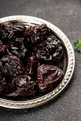 Prunes dried fruit smoked plum snack fresh delicious gourmet food background on the table rustic food top view copy space keto and paleo diet vegetarian and vegan food