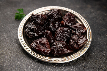 Prunes dried fruit smoked plum snack fresh delicious gourmet food background on the table rustic food top view copy space keto and paleo diet vegetarian and vegan food