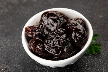 Prunes dried fruit smoked plum snack fresh delicious gourmet food background on the table rustic food top view copy space keto and paleo diet vegetarian and vegan food