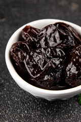Prunes dried fruit smoked plum snack fresh delicious gourmet food background on the table rustic food top view copy space keto and paleo diet vegetarian and vegan food