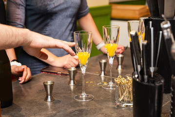 Bartending class preparing orange cocktails.
