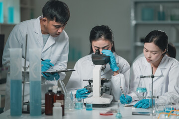 Researchers collaborate in a cutting-edge DNA laboratory, analyzing samples on petri dishes to...