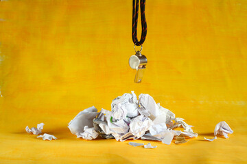 Coaching,consulting,mentor business concept with crumpled paper and sports trainer whistle, free...