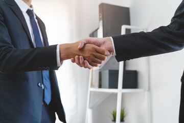 close-up view hand of client and banker shaking hands  on the meeting table after business...