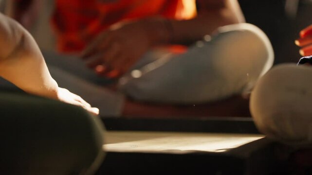 Fingers poised for a perfect strike during an intense carrom board game match at home