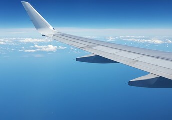Obraz premium Airplane wing above clouds and ocean