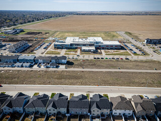 Residential area with a large empty lot in the background