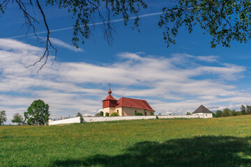 Kostel svaté Kateřiny Alexandrijské u Stříbrných Hor / Church of Saint Catherine of Alexandria Near Stříbrné Hory Surrounded by Green Meadows and Blue Spring Sky