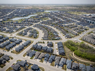 Suburban neighborhood with houses and a lake in the background